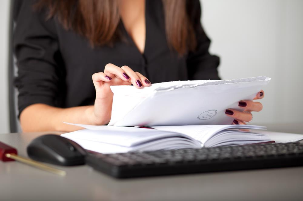Startup founder opening mail as part of the services provided by a virtual office solution in Singapore.